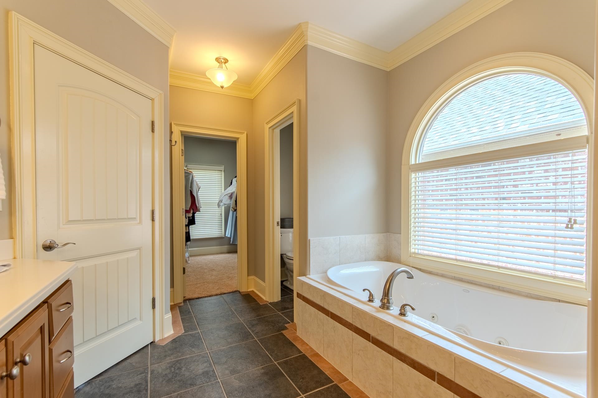 116 Sunset Drive Clifton, TN 38425 - Photo 15 of 40 a bathroom with a tub a sink and a window