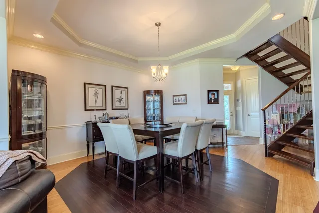 a view of a a dining room with furniture window and wooden floor