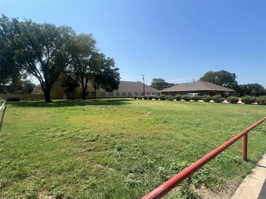a view of a green field with sitting area