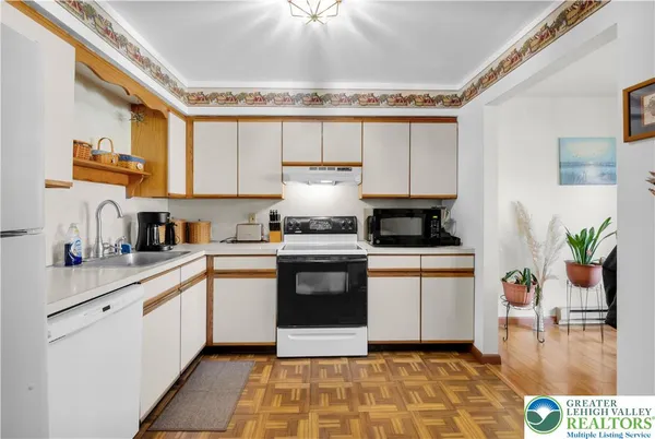 a kitchen with a sink cabinets and window