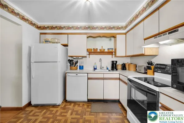 a kitchen with a refrigerator and a sink