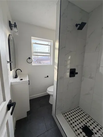a bathroom with a sink toilet and shower