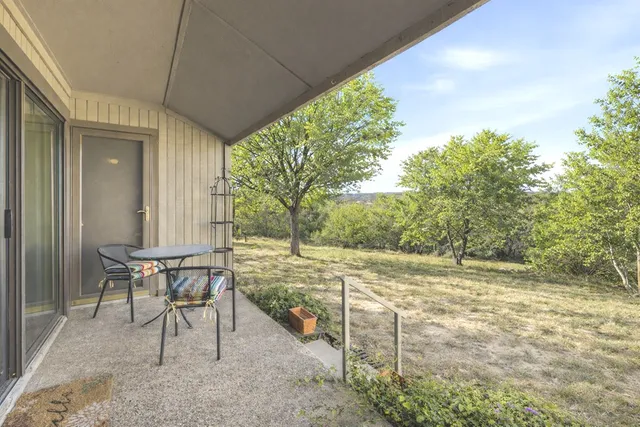 a view of a patio with table and chairs and potted plants