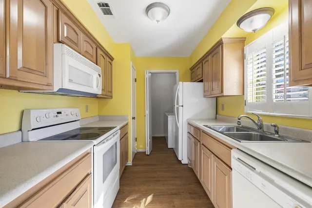 a kitchen that has a sink and a stove