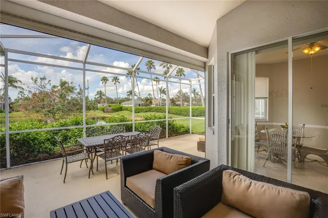 a living room with couch and a floor to ceiling window