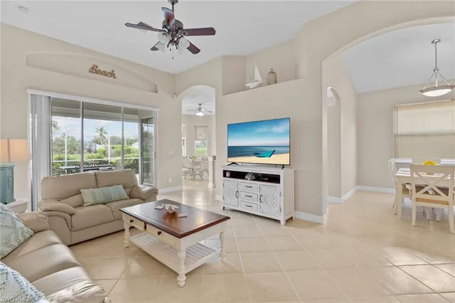 a living room with furniture a large window and a flat screen tv