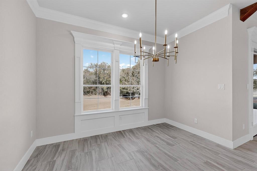 1161 Gonzollas Road Springtown, TX 76082 - Photo 14 of 40 a view of a room with wooden floor chandelier and windows