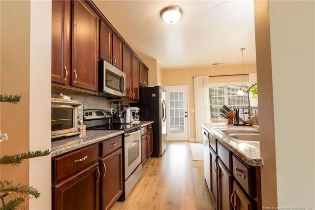 a kitchen with a sink and a refrigerator