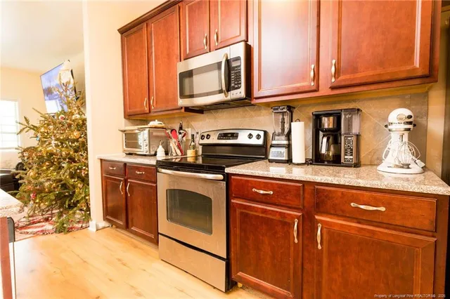 a view of a dining room with furniture and a chandelier