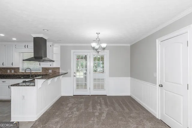 a kitchen with stainless steel appliances granite countertop a stove and a refrigerator