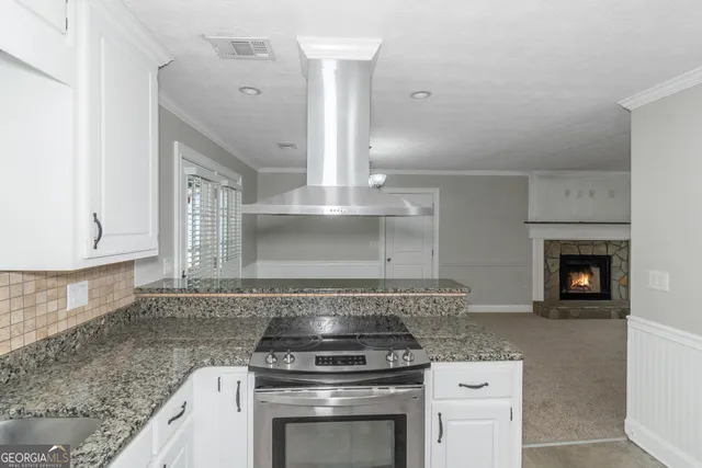 a kitchen with granite countertop a stove and a sink