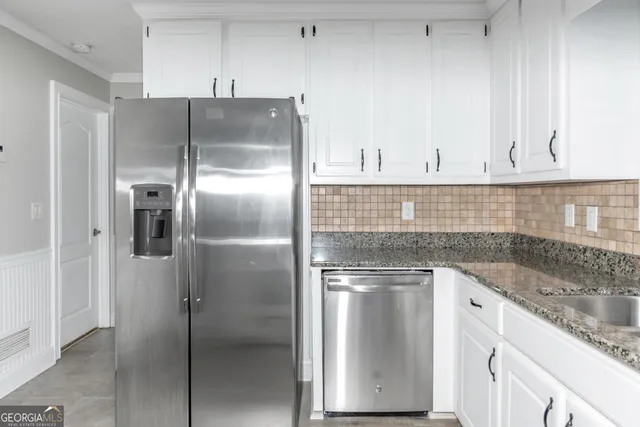 a kitchen with cabinets and stainless steel appliances