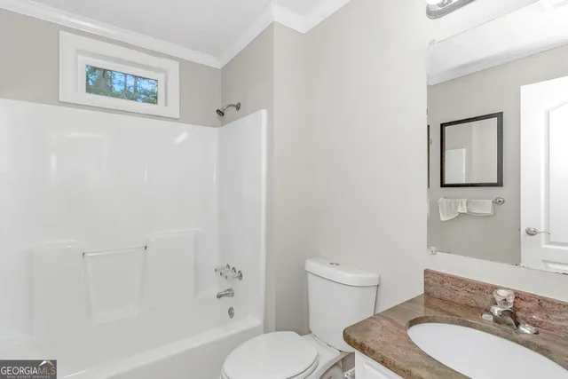 a bathroom with a toilet a sink and a mirror