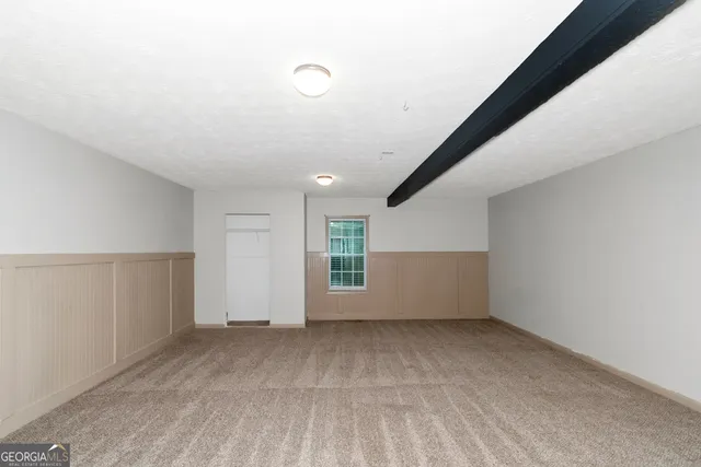 an empty room with a empty space and windows