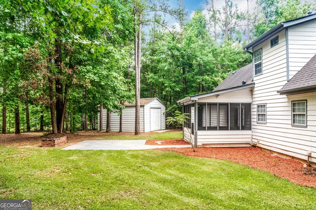 a front view of a house with a yard and tree s