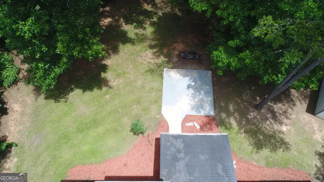 an aerial view of a house with a yard