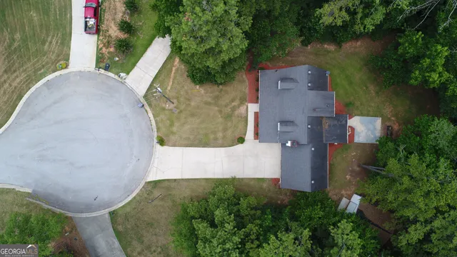 an aerial view of a house with outdoor space and a lake view