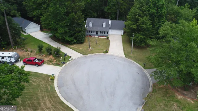 an aerial view of a house with outdoor space