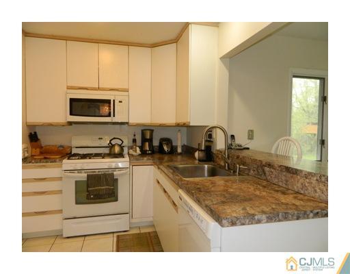 5 Hamlin Road East Brunswick, NJ 08816 - Photo 5 of 16 a kitchen with stainless steel appliances granite countertop a stove a sink and a microwave