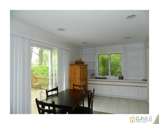 5 Hamlin Road East Brunswick, NJ 08816 - Photo 8 of 16 a living room with a table and a large window