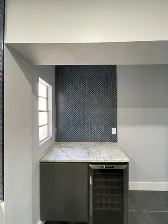 a kitchen with granite countertop cabinets and window