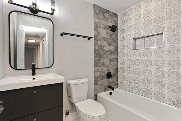 a bathroom with a toilet sink shower and mirror