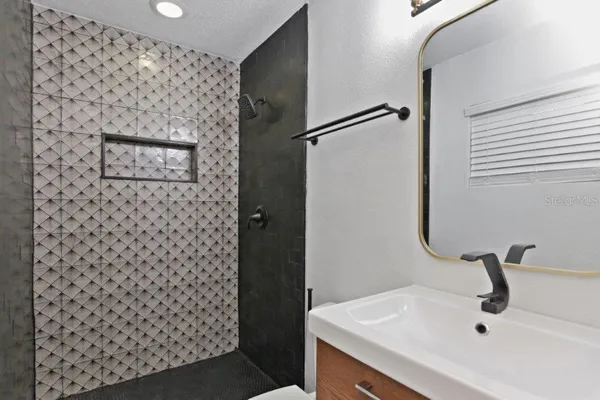 a bathroom with a sink and mirror