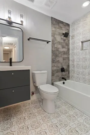 a bathroom with a toilet a sink and bathtub