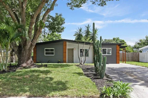 a front view of house with yard and trees