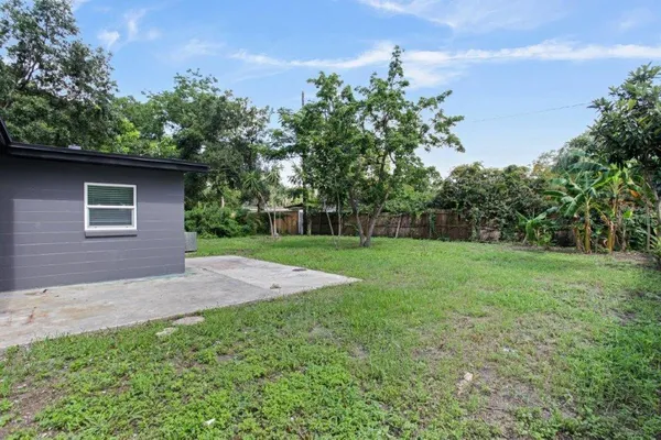 a view of a yard with a house in the background