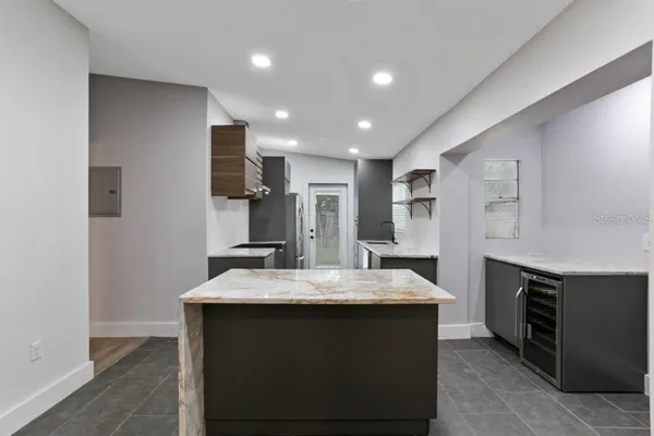 a kitchen with sink cabinets and refrigerator