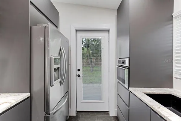 a kitchen with a refrigerator and a sink