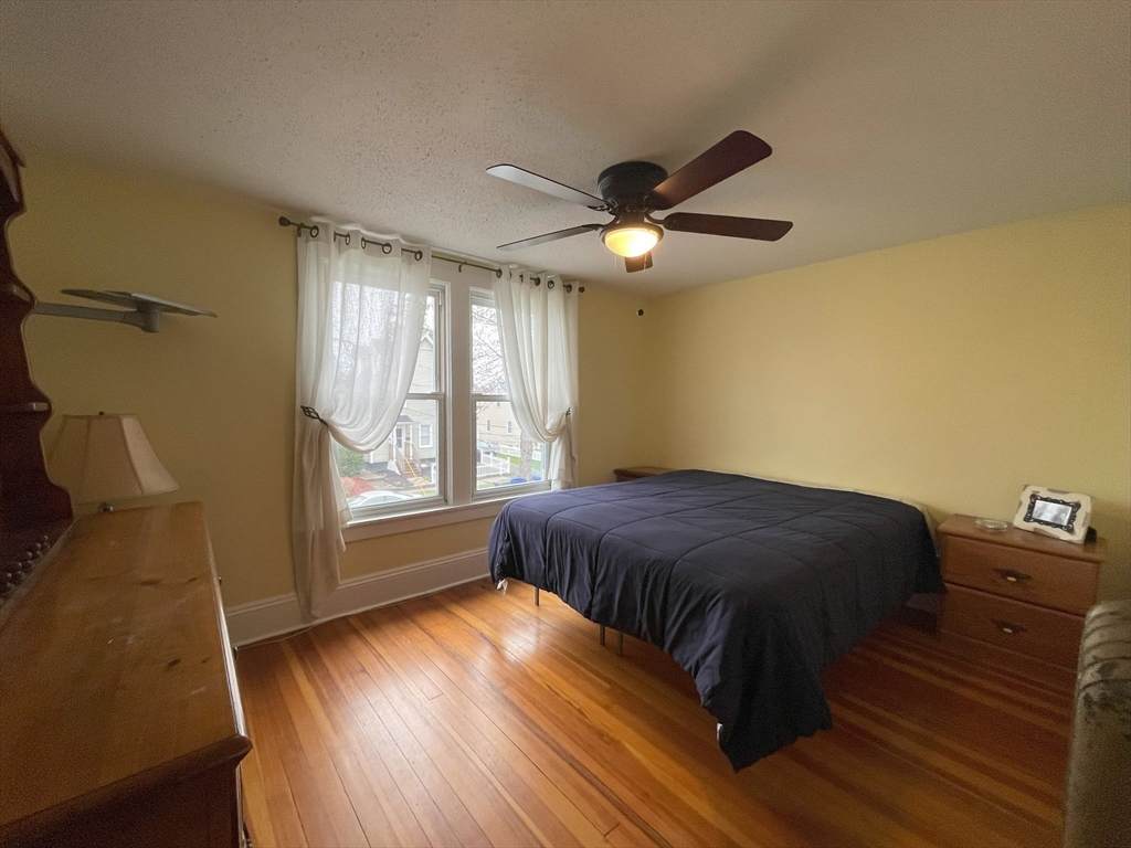 93 Farnsworth Street Springfield, MA 01107 - Photo 18 of 24 a bedroom with a bed and a window
