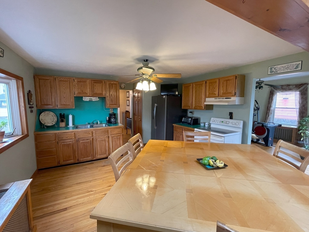 93 Farnsworth Street Springfield, MA 01107 - Photo 5 of 24 a large kitchen with a lot of counter space and wooden floor