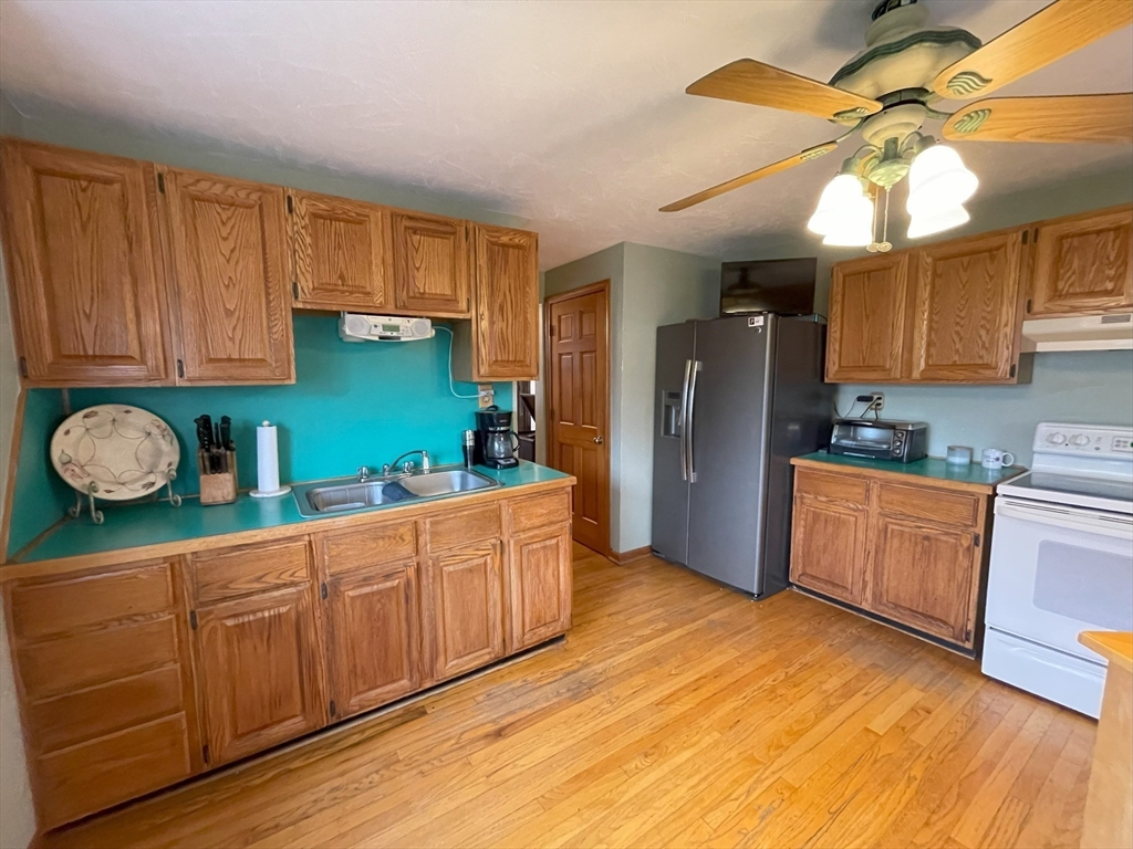 93 Farnsworth Street Springfield, MA 01107 - Photo 8 of 24 a kitchen with granite countertop wooden cabinets and stainless steel appliances