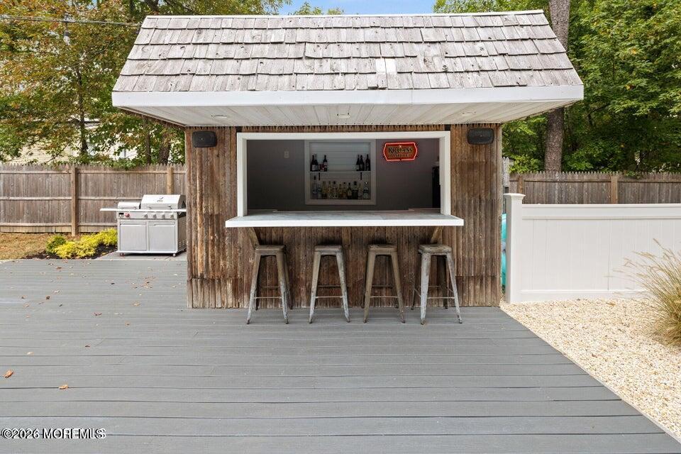 12 6th Street Barnegat, NJ 08005 - Photo 29 of 37 a view of a patio with table and chairs with wooden floor and fence