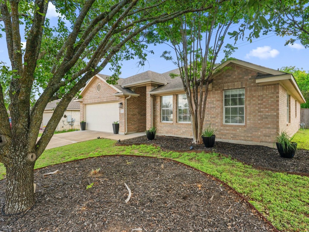 1201 Ridgewood Drive Leander, TX 78641 - Photo 26 of 29 Ranch-style home with brick siding, driveway, and an attached garage