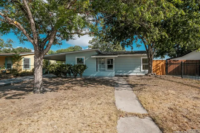 a view of a house with a tree in front