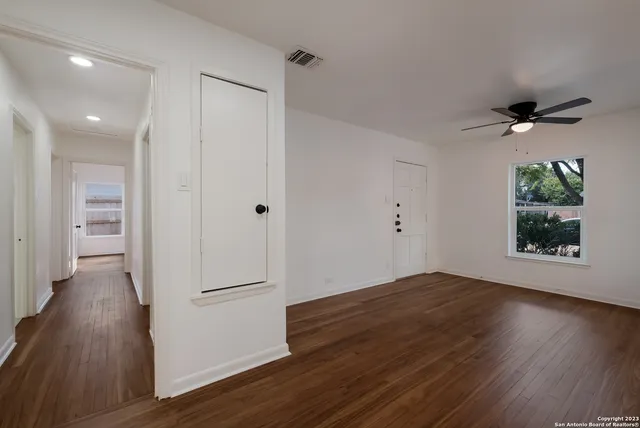 wooden floor in an empty room with a window