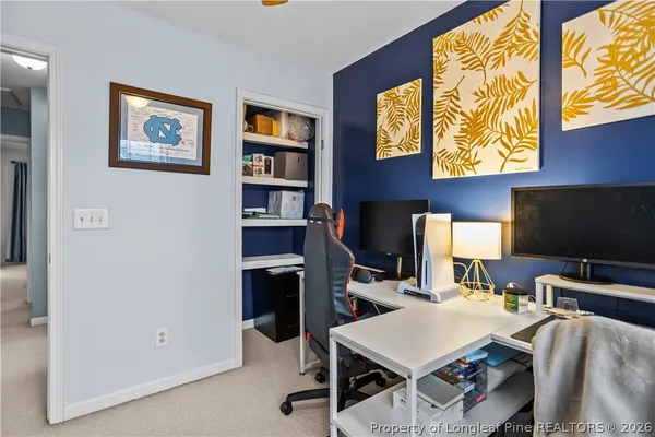 a view of a livingroom with furniture and a flat screen tv