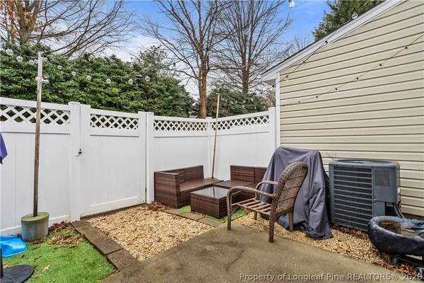 a view of a chairs and table in backyard