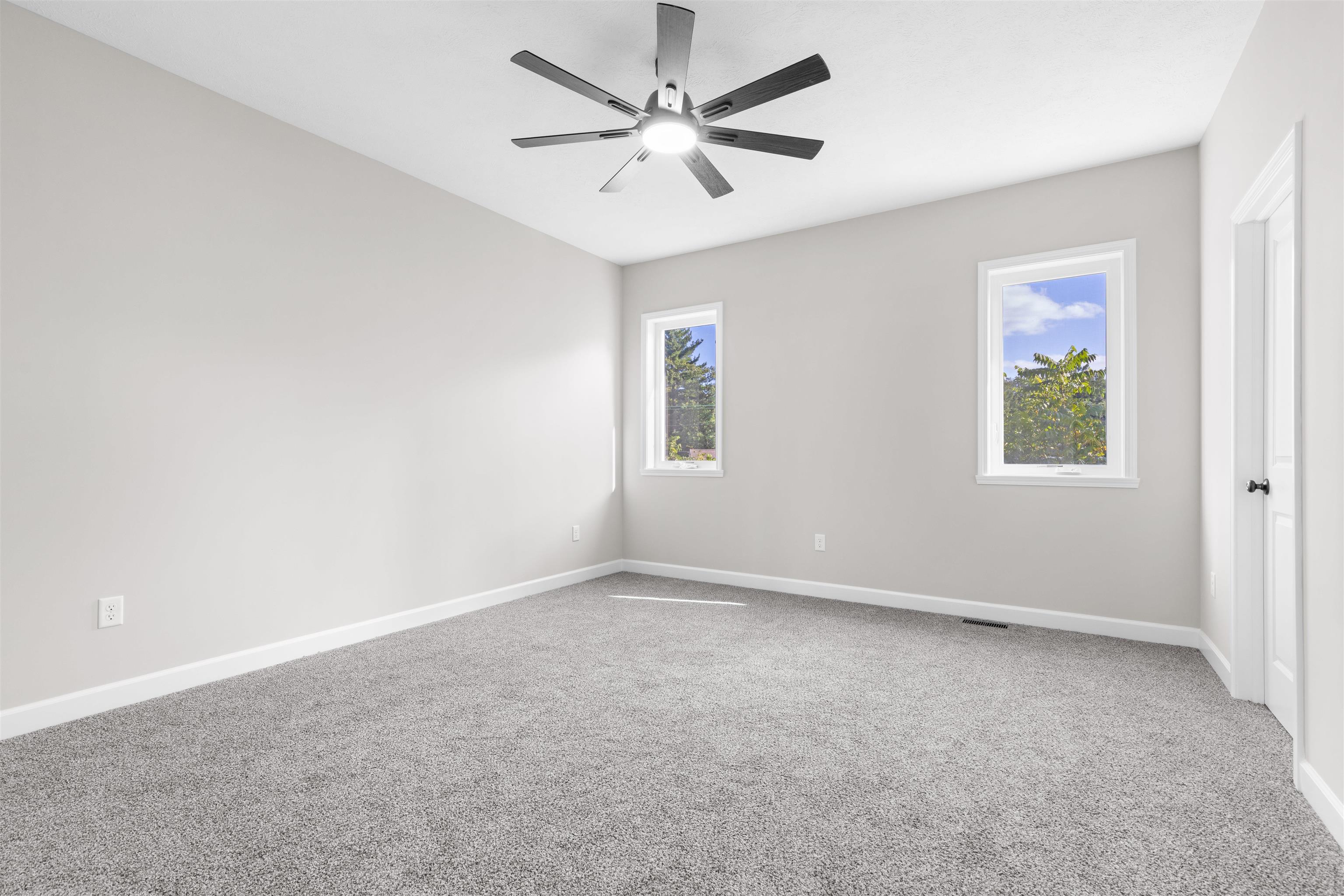 7743 Cherry Hill Road Cherry Valley, IL 61016 - Photo 9 of 18 an empty room with windows and fan
