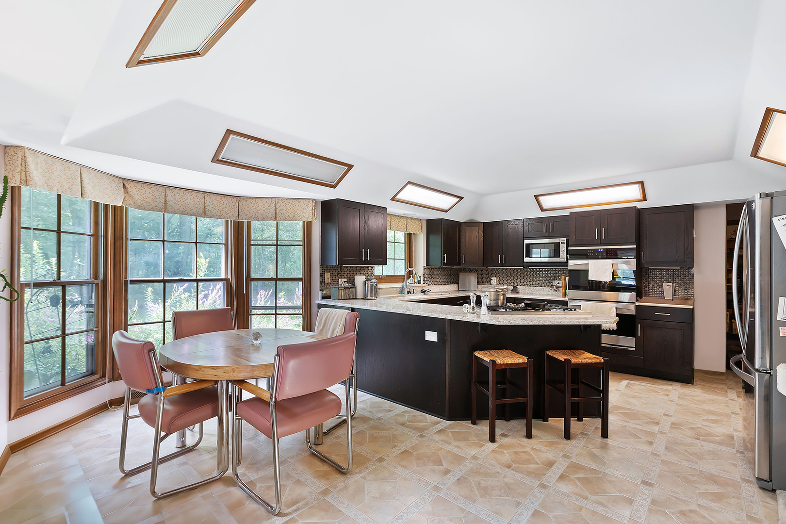 2647 Sun Valley Road Lisle, IL 60532 - Photo 7 of 26 a kitchen with a dining table chairs and refrigerator