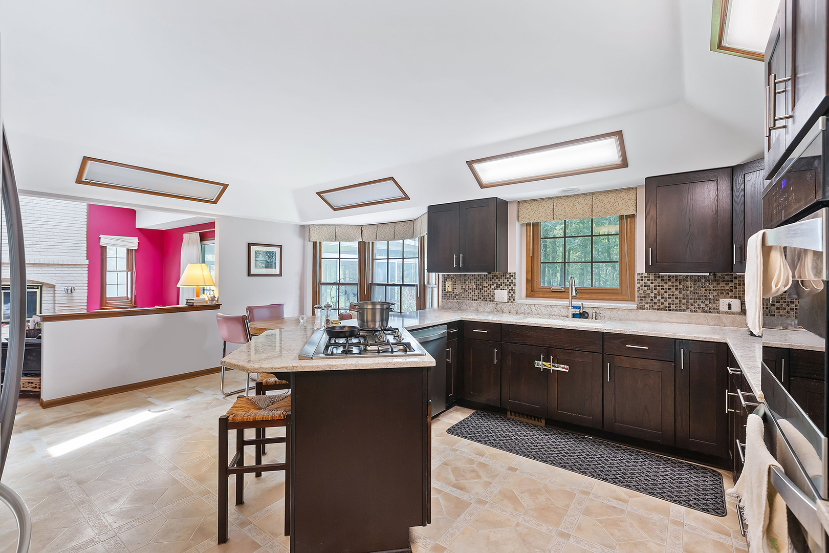 2647 Sun Valley Road Lisle, IL 60532 - Photo 8 of 26 a large kitchen with kitchen island a sink table and chairs