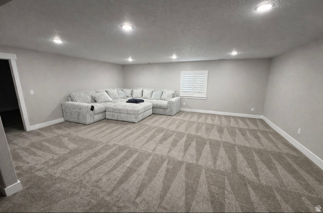 2350 North 1075 West Helper, UT 84526 - Photo 26 of 49 Unfurnished living room with a textured ceiling, recessed lighting, and light carpet