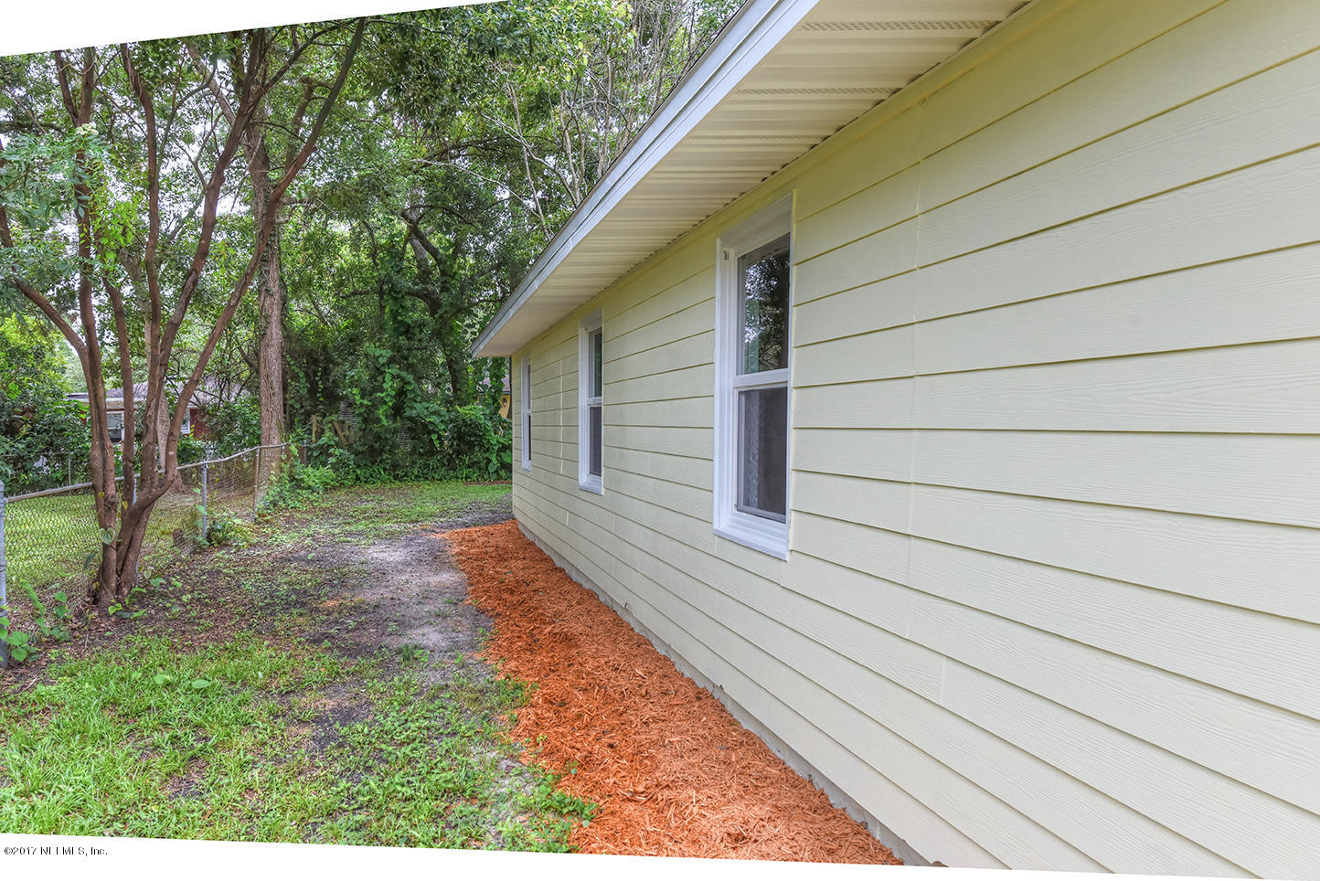 4640 Tanbark Road Jacksonville, FL 32210 - Photo 26 of 28 a backyard of a house with lots of green space