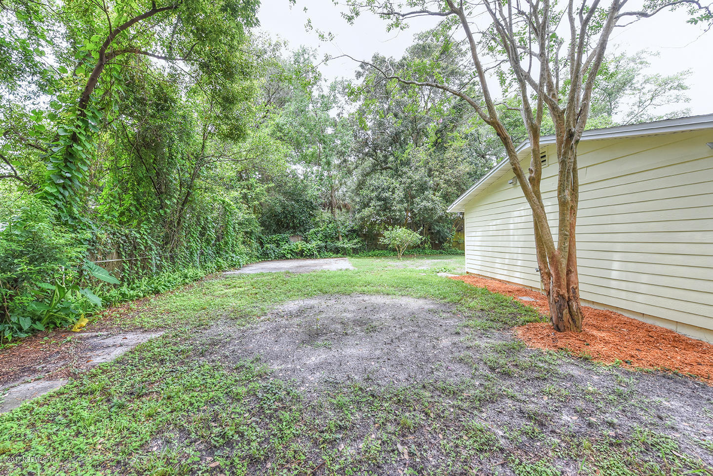 4640 Tanbark Road Jacksonville, FL 32210 - Photo 27 of 28 a view of a house with backyard and garden