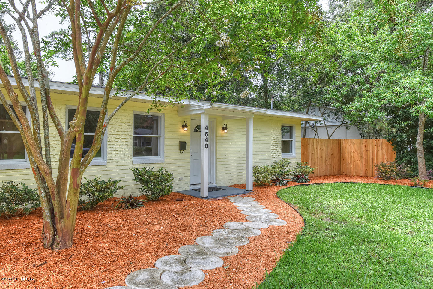 4640 Tanbark Road Jacksonville, FL 32210 - Photo 3 of 28 a front view of a house with garden