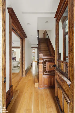 a kitchen with stainless steel appliances a sink and wooden floor