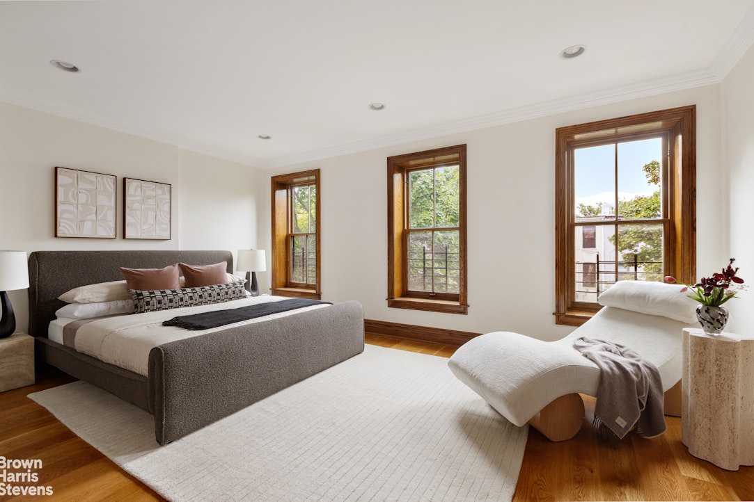 577 Jefferson Avenue Brooklyn, NY 11221 - Photo 11 of 16 a bedroom with a bed and a large window